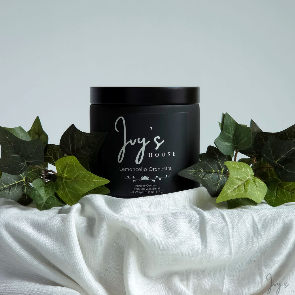 Lemoncello Orchestra premium scented candle by Ivy’s House with ivy leaves on soft white fabric