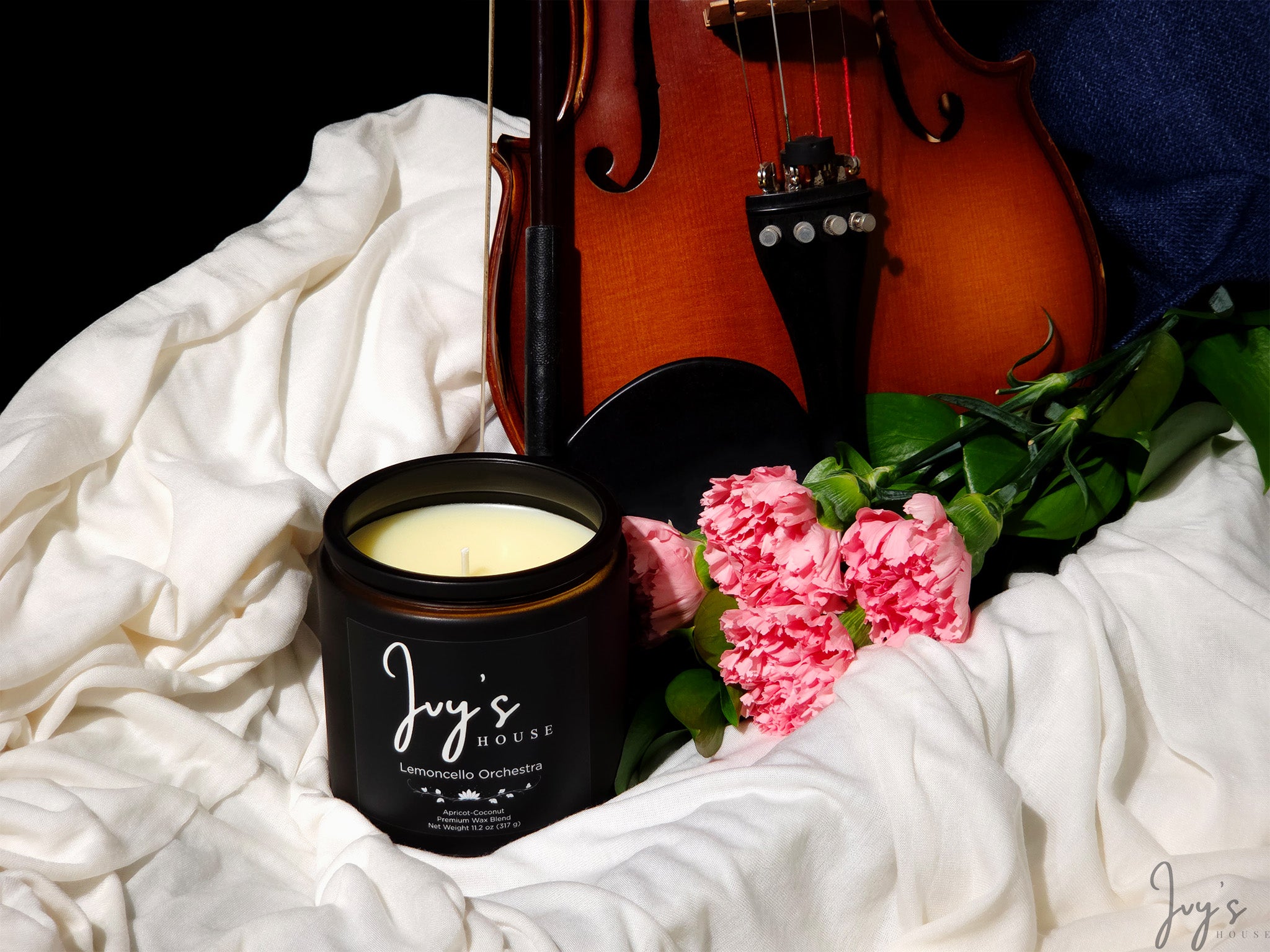 Lemoncello Orchestra candle by Ivy’s House with violin and pink flowers on soft fabric