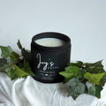 Wandering Willow premium scented candle by Ivy’s House with ivy leaves on soft white fabric