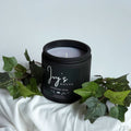 Wildflower Song premium scented candle by Ivy’s House with ivy leaves on soft white fabric